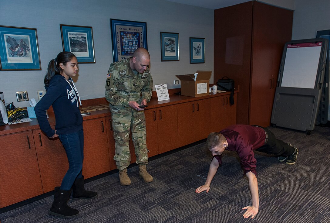 Matthew Rush, 16, performs pushups during the Fitness Challenge at DSCC's 'Take our daughters and sons to work day’. Rush was one of more than 100 children aged 9-17 who attended the April 27 event aimed at educating children about the contributions their parents and guardians make to warfighter support.