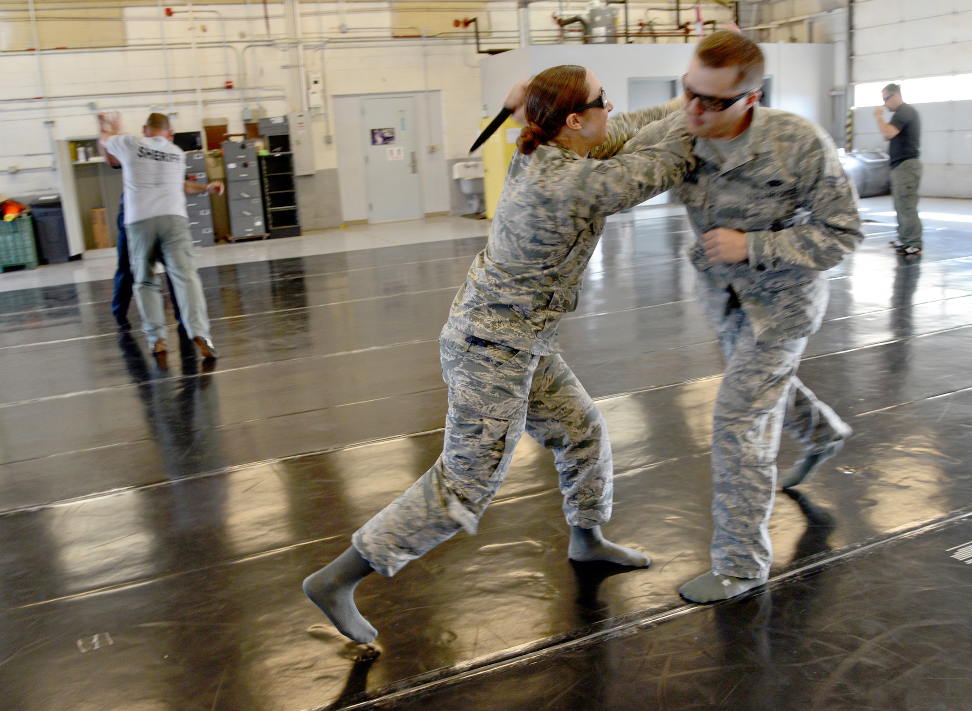 Senior Airmen Cassie Loveland and David Spellman, both with the 72nd Security Forces Squadron, practice offensive and defensive hand-to-hand combat moves during a training course hosted by Blue Shield Tactical Systems. The Airmen trained side-by-side with officers from The Village Police Department and Muskogee Campus Police Department during the two day course April 10-11. (Air Force photo by Kelly White)