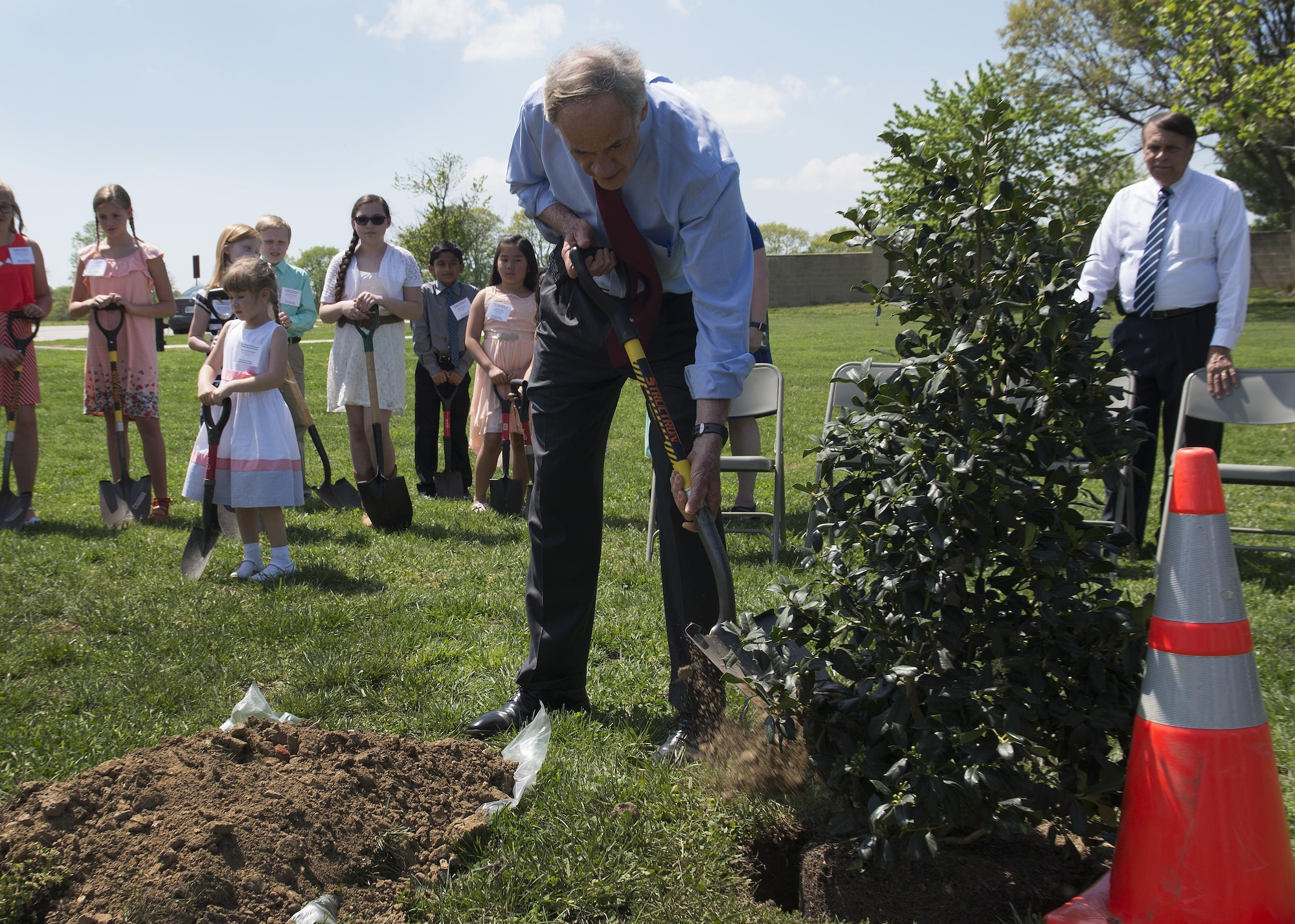 Sen. Tom Carper, Del., shovels dirt to plant a tree at the State of Delaware Arbor Day event April 28, 2017, at Dover Air Force Base, Del. The tree is an American Holly, the official state tree of Delaware. (U.S. Air Force photo by Senior Airman Zachary Cacicia)