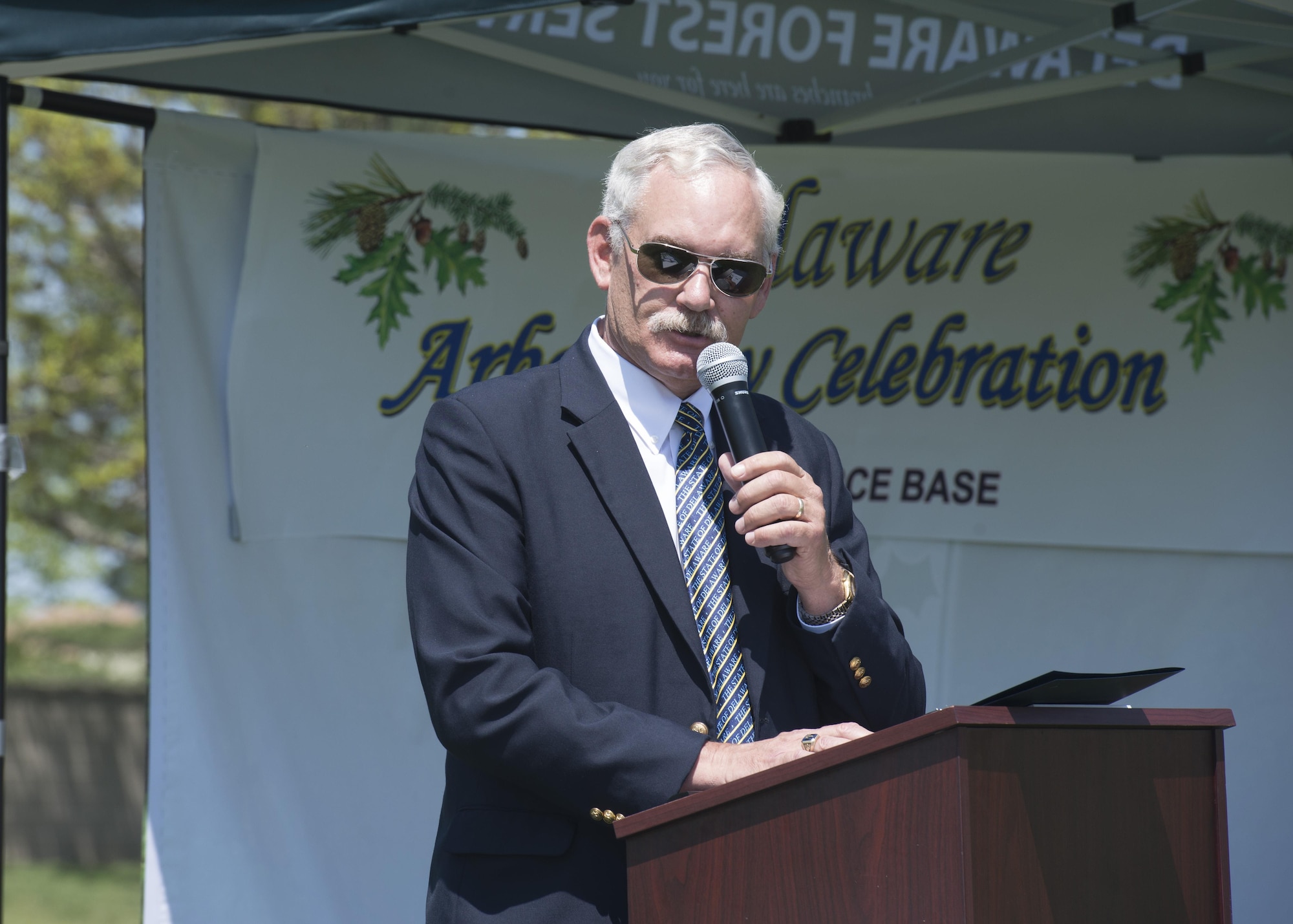 Delaware Secretary of Agriculture Michael Scuse speaks at the State of Delaware Arbor Day event April 28, 2017, at Dover Air Force Base, Del. The event also feature awards for elementary school students who took part in an Arbor Day poster contest. (U.S. Air Force photo by Senior Airman Zachary Cacicia)