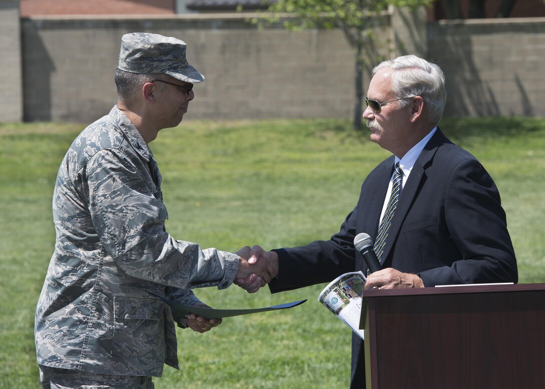Col. Randy Boswell, 436th Mission Support Group commander, accepts the Tree City USA 25 Year certificate from Delaware Secretary of Agriculture Michael Scuse April 28, 2017, at Dover Air Force Base, Del. Boswell accepted the certificate on behalf of Dover AFB. (U.S. Air Force photo by Senior Airman Zachary Cacicia)