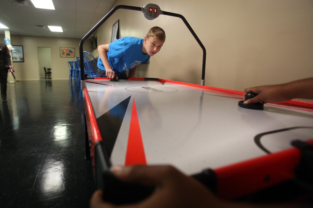 Children play games in their new facilities during a Boys & Girls Club opening at New Bern, N.C., April 24, 2017. Marines assigned to Marine Wing Support Squadron 272, Marine Aircraft Group 26, 2nd Marine Air Wing joined the local community for the reveal of the youth center after it was constructed from the remains of an old nightclub. 13 Marines assigned to the squadron volunteered for the construction of the facility. (U.S. Marine Corps photo by Sgt. N.W. Huertas/Released)