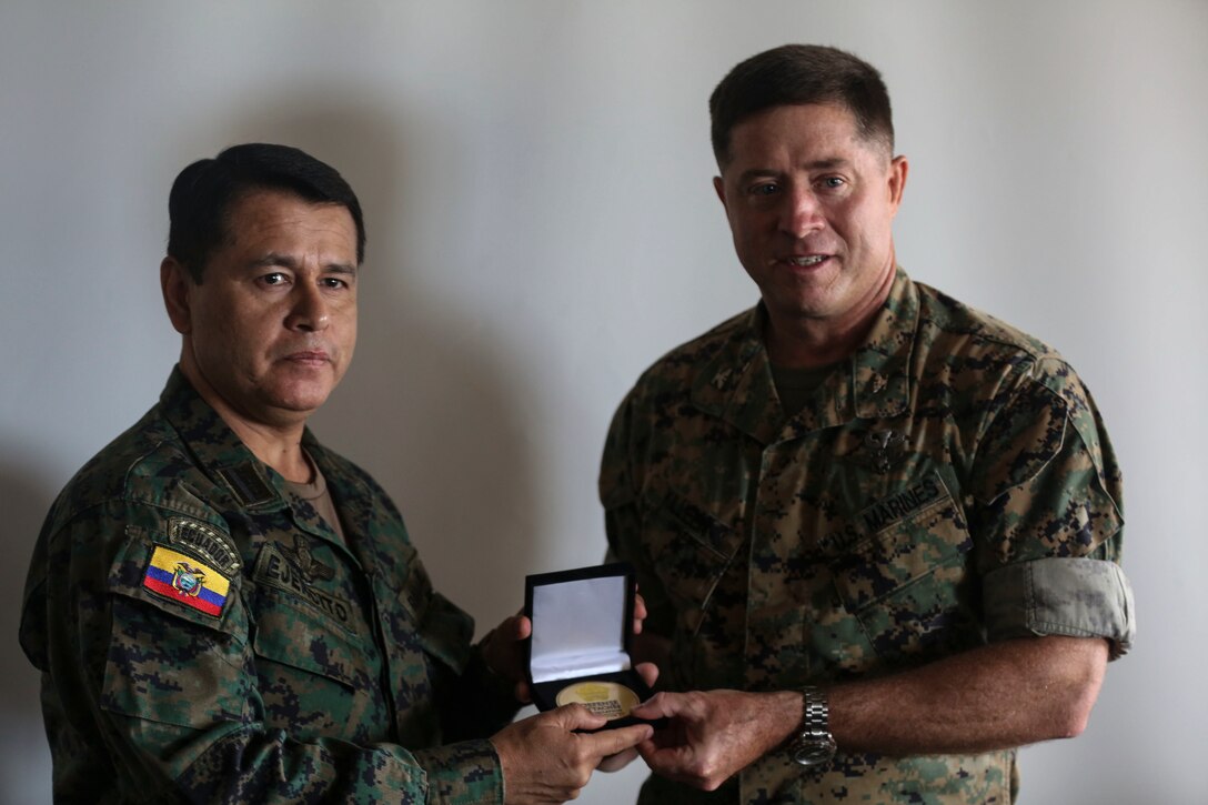Colonel Ronier Ramirez, Ecuador (Left), presents Colonel Sean Killeen (Right) the Defense Attaché award aboard Marine Corps Base Hawaii, April 26, 2017. The Operations Orientation Program takes many foreign defense attachés on a tour of different regions in the United States giving them exposure to military capabilities, different aspects of American culture, and some of our cities and attractions around the country. (U.S. Marine Corps Photo by Lance Cpl. Matthew Kirk)