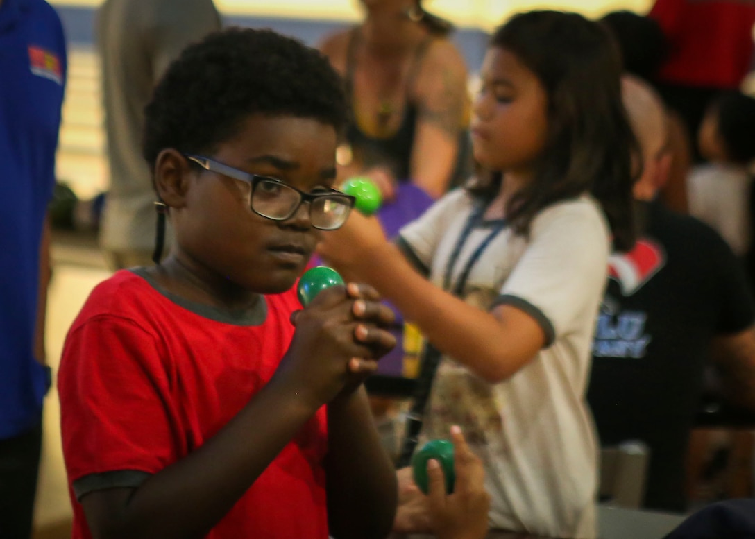 Kaiden Parrish squeezes a stress ball during the annual “Strike Out Child Abuse” event at K-Bay Lanes aboard Marine Corps Base Hawaii, April 26, 2017. The purpose of this event was to raise awareness and reach out to the community about ways to protect children from abuse. (U.S. Marine Corps Photo by Lance Cpl. Matthew Kirk)