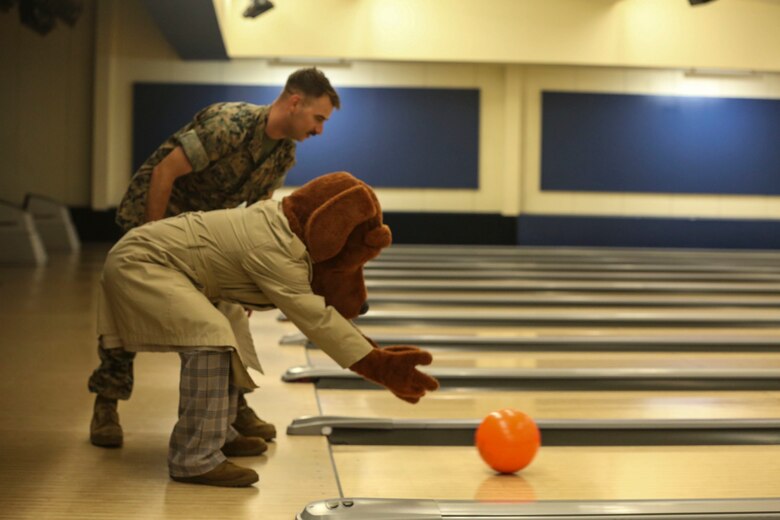 “McGruff the Crime Dog” rolls a bowling ball during the annual “Strike Out Child Abuse” event at K-Bay Lanes aboard Marine Corps Base Hawaii, April 26, 2017. The purpose of this event was to raise awareness and reach out to the community about ways to protect children from abuse. (U.S. Marine Corps Photo by Lance Cpl. Matthew Kirk)