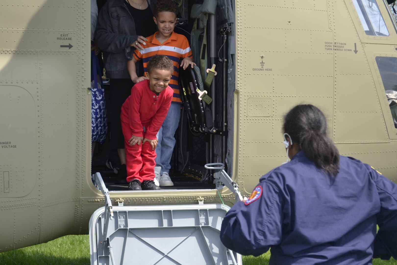 Elijah, 4, (in red) and Robert, 6, prepare to exit a Chinook CH-47 on display at Naval Support Activity Philadelphia during Take Our Daughters and Sons to Work Day April 27. More than 440 children participated in interactive activities to learn more about the military and missions of DLA Troop Support and NAVSUP Weapon Systems Support.