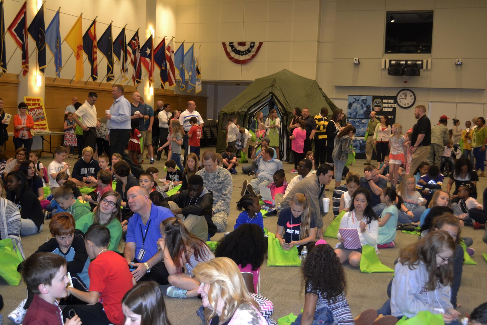 Children and parents gather on the floor of the DLA Troop Support Bldg. 6 auditorium at the start of Take Our Daughters and Sons to Work Day April 27, 2017. More than 440 children participated in interactive activities to learn more about the missions of DLA Troop Support and NAVSUP Weapon Systems Support. Photo by Agneta Murnan Children and parents gather on the floor of the DLA Troop Support Bldg. 6 auditorium at the start of Take Our Daughters and Sons to Work Day April 27, 2017. More than 440 children participated in interactive activities to learn more about the missions of DLA Troop Support and NAVSUP Weapon Systems Support. 
