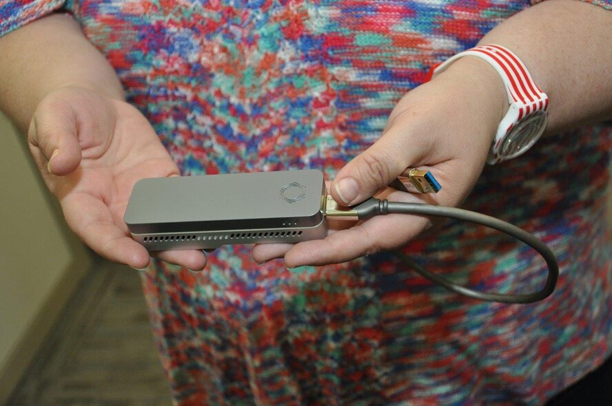 The size of the newest generation genome sequencer illustrates the huge leap in technological advances from its predecessor. The new device could potentially be utilized in the field and provide commanders with information formerly available only the lab and in far less time. (U.S. Air Force photo/Will Huntington)