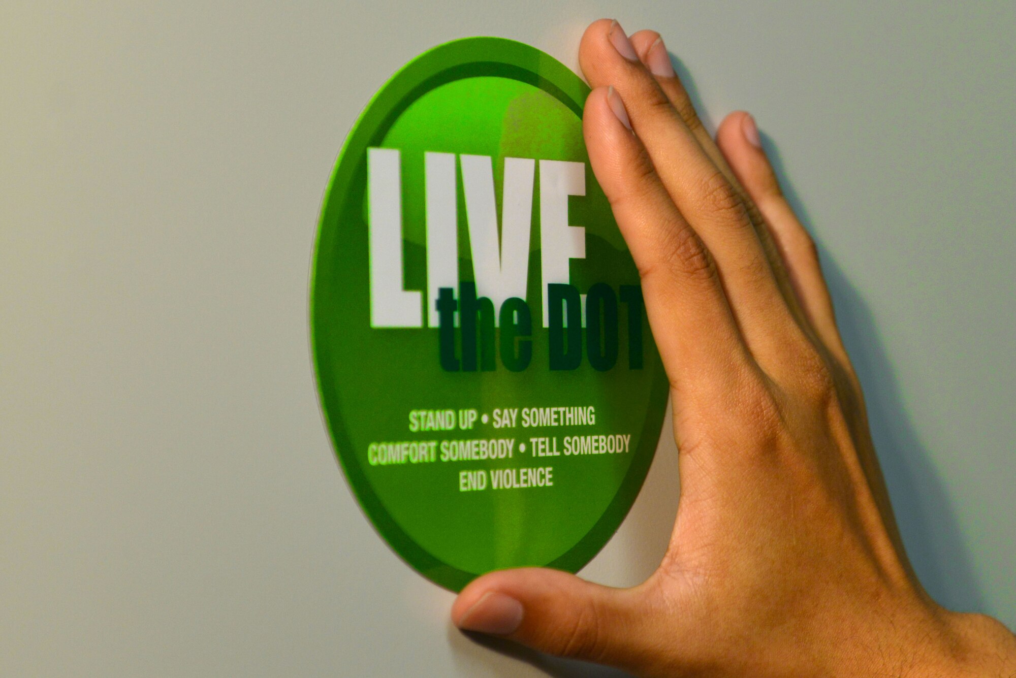 There are two types of Green Dots: proactive and reactive. An example of a proactive Green Dot is posting a “Live the Dot” magnet, which can start a conversation about preventing interpersonal violence. A reactive Green Dot is intervening in a situation where interpersonal violence may happen. (U.S. Air Force illustration by Airman 1st Class Destinee Sweeney)