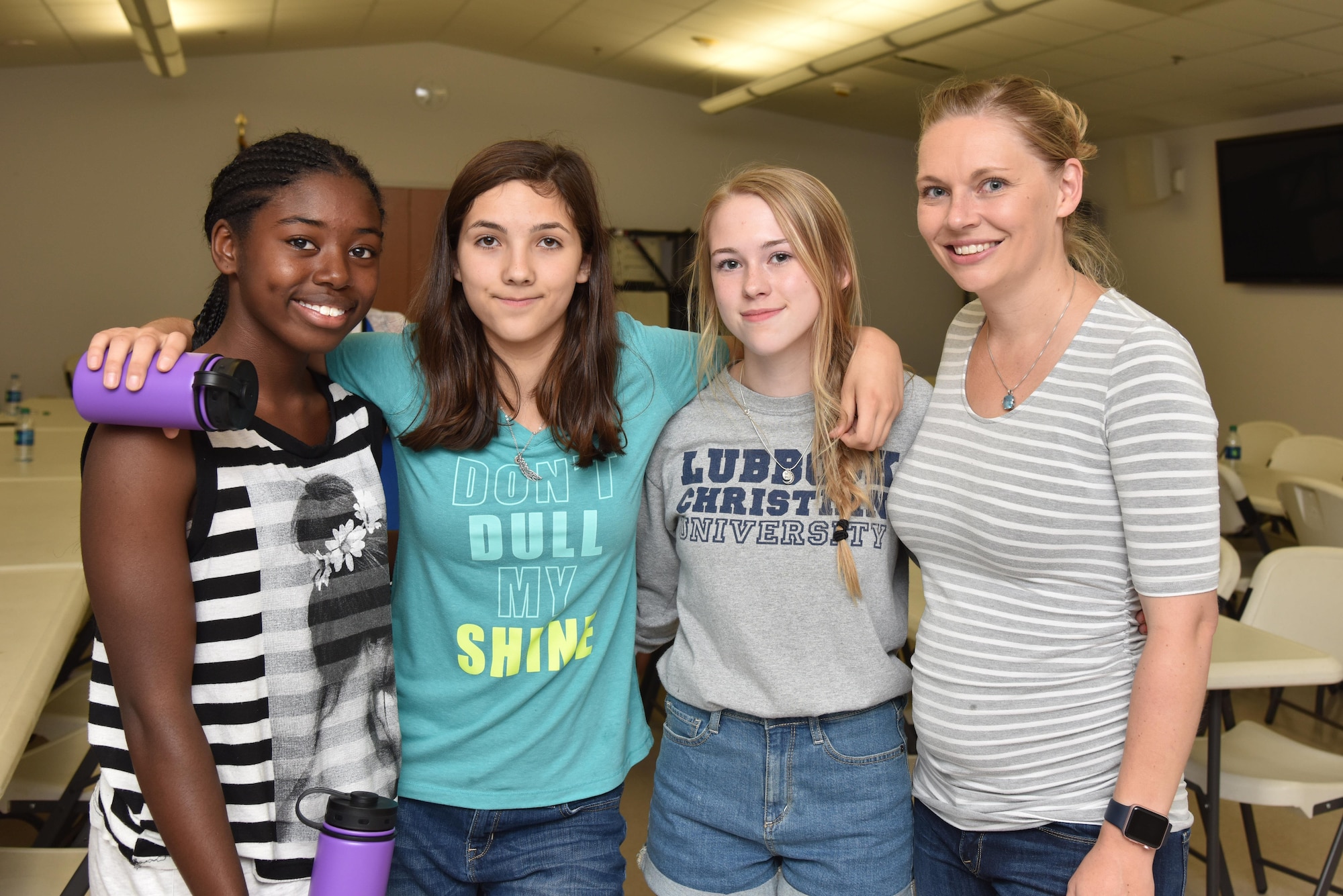 (Left) Ki Wilburn, Lizzy Maldonado, and Ashtyn Reed pose with Elizabeth Burmeister, 17th Medical Operations Squadron health promotion coordinator, during Teen Chef Challenge at the Taylor Chapel on Goodfellow Air Force Base, Texas, April 28, 2017. Burmeister held the contest to teach teens about healthy eating and portion control.  (U.S. Air Force photo by Staff Sgt. Joshua Edwards/Released)