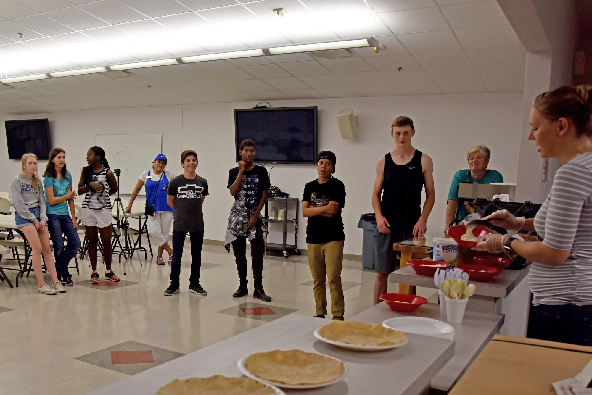 Elizabeth Burmeister, 17th Medical Operations Squadron health promotion coordinator, explains the rules of Teen Chef Challenge at the Taylor Chapel on Goodfellow Air Force Base, Texas, April 28, 2017. The teens had to make a yogurt parfait and quesadilla for the contest. (U.S. Air Force photo by Staff Sgt. Joshua Edwards/Released)