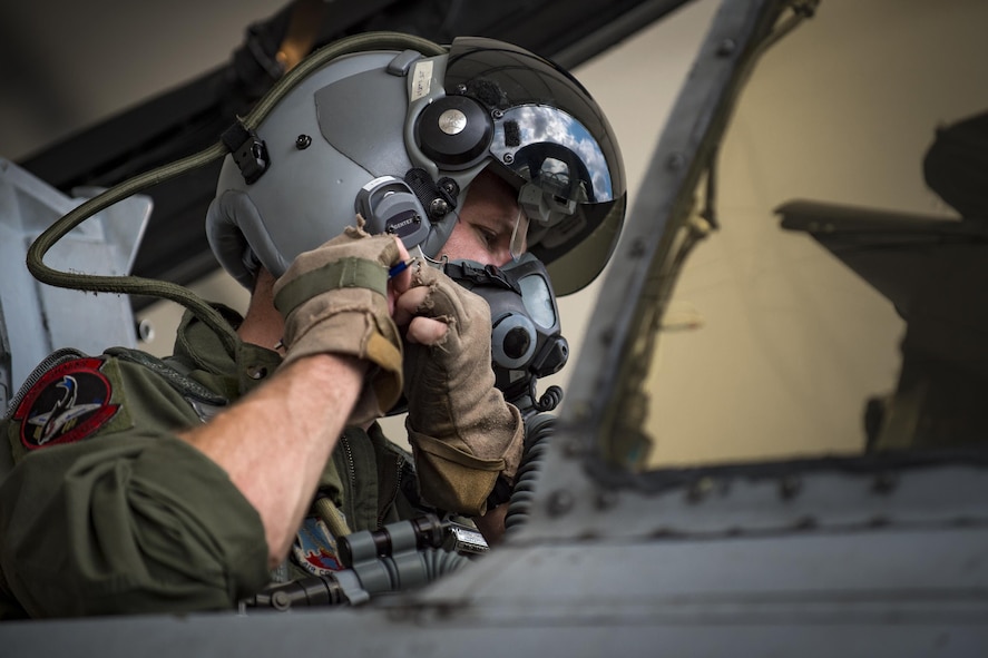An A-10C Thunderbolt II pilot from the 75th Fighter Squadron fastens his helmet prior to take off, April 28, 2017, at Moody Air Force Base, Ga. The 75th FS departed for Combat Hammer, an air-to-ground exercise hosted at Hill Air Force Base, Utah. The exercise is designed to collect and analyze data on the performance of precision weapons and measure their suitability for use in combat. (U.S. Air Force photo by Andrea Jenkins)