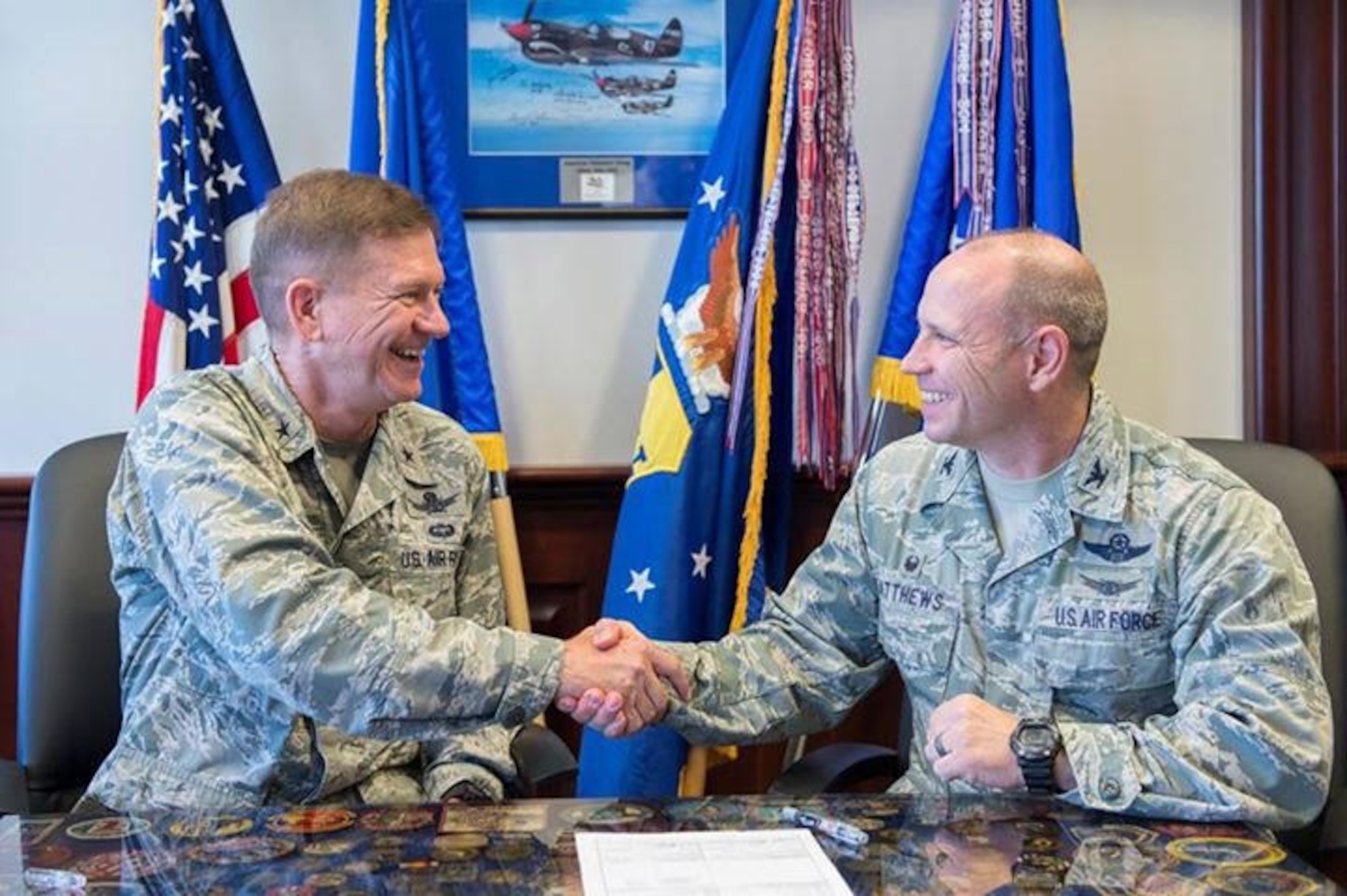 Brig. Gen. Wayne R. Monteith, left, 45th Space Wing commander, and Col. Kurt A. Matthews, 920th Rescue Wing commander, shake hands after signing a robust new support agreement April 21, 2017, to solidify their mission partnership. Even though the missions are distinctly different, working together ensures they maintain the greatest Air Force in the world. (U.S. Air Force photo/Matthew Jurgens)