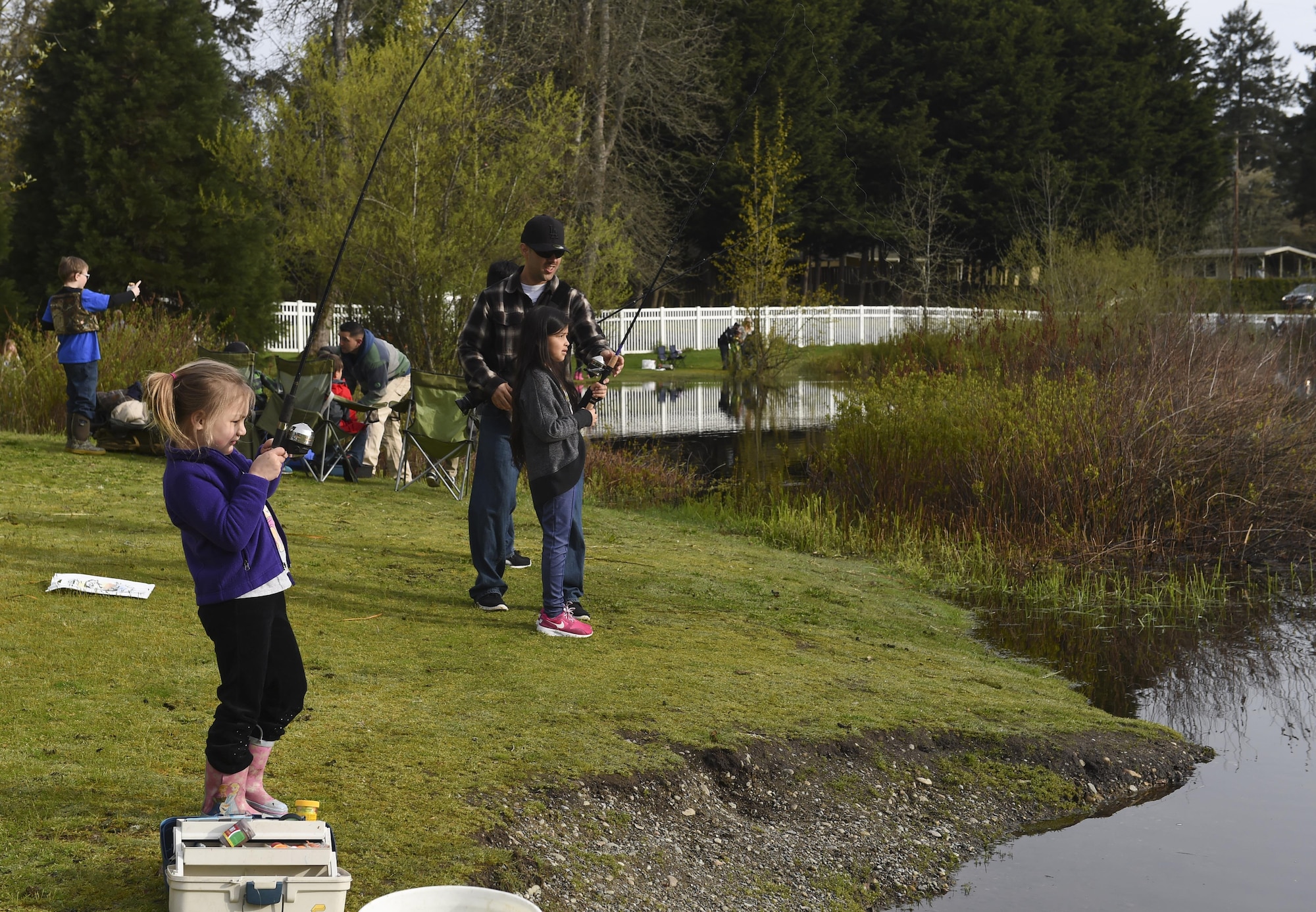 Children and their families fish during this year’s Annual McChord Field Top III Fishing Derby April 29, 2017, at Carter Lake on Joint Base Lewis-McChord, Wash. The Washington Department of Fish and Wildlife provided more than 1,500 fish to make this fishing derby possible. (U.S. Air Force Photo/ Staff Sgt. Naomi Shipley)