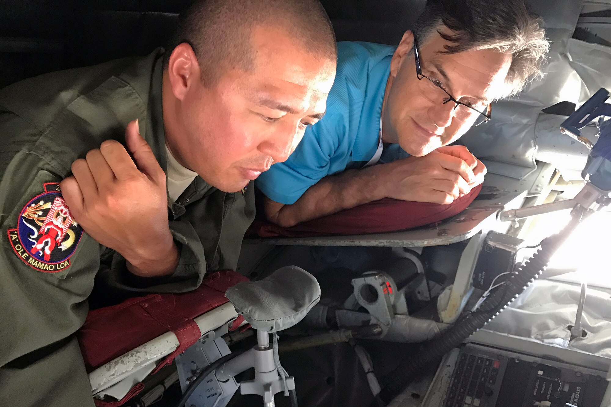 U.S. Air Force Staff Sgt. Travis Kam, a boom operator with the Hawaii Air National Guard, explains refueling procedures to Dr. Kenneth Delano, an employer from Kahi Mohala Behavioral Health Center during an Employer Support of the Guard and Reserve "Breakfast with the Boss" and KC-135 Stratotanker tour April 2, 2017. Senior Master Sgt. Diane C. Marques of the 48th Aerial Port Squadron nominated Delano for a Patriot Award, which recognizes individual supervisors who have made special efforts to support Citizen-Warriors and their spouses. ESGR looks to foster knowledge, understanding and serve as the bridge between Reserve Component service members and their civilian employers. Located on Oahu and Guam, and a component of the Air Force Reserve, the 624th RSGs mission is to deliver mission essential capability through combat readiness, quality management and peacetime deployments to any area of responsibility, (U.S. Air Force photo by Master Sgt. Theanne Herrmann) 