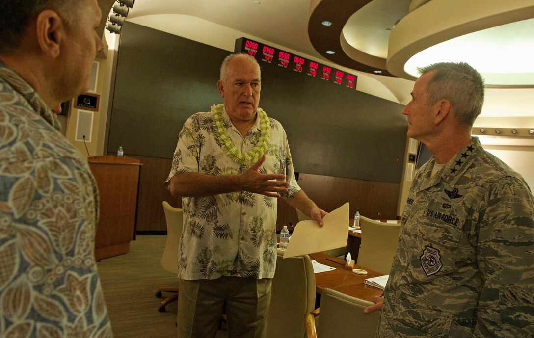Former University of Hawaii (UH) head football coach June Jones (center) talks with U.S. Air Force Gen. Terrence J. O'Shaughnessy, Pacific Air Forces (PACAF) commander (right), during the PACAF hosted commander's conference at Joint Base Pearl Harbor-Hickam, Hawaii, April 26, 2017. At UH, Jones guided the Rainbow Warriors to what was the biggest single-season turnaround in NCAA history, taking a program that had gone 0-12 before his arrival to 9-4 in 1999, leaving the school as the winningest head coach with a 76-41 record over nine seasons. The three-day conference included a wide variety of topics and several guest speakers, preparing leaders in PACAF to remain poised to retain a competitive advantage in the evolving Pacific theater. (U.S. Air Force photo by Tech. Sgt. Kamaile Chan)