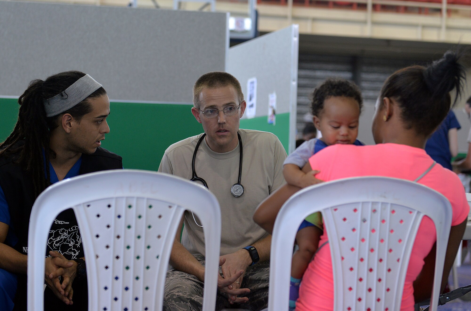 U.S. Air Force Maj. David Sayers, a pediatrician with the 21st Medical Operations Squadron out of Peterson Air Force Base, Colo., advises the mother of a patient with the assistance of a local medical student volunteer in Azua, Dominican Republic, March 14, 2017, during a medical readiness training exercise as part of NEW HORIZONS 2017. Non-governmental organization (NGO)/private voluntary organization and private sector participation in NEW HORIZONS, coordinated with 12th Air Force, U.S. Southern Command, the Department of State, and the U.S. agency for International Development, nurtures partnerships between the military services, governmental, NGOs, and host-nation teams to ensure partnerships are in place in the event of a regional contingency requiring cooperative solutions. (U.S. Air Force photo by Master Sgt. Karen J. Tomasik)