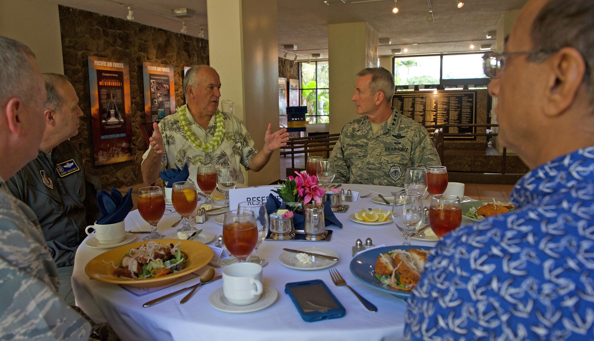 Former University of Hawaii (UH) head football coach June Jones (left) talks with U.S. Air Force Gen. Terrence J. O'Shaughnessy, Pacific Air Forces (PACAF) commander during a luncheon for the PACAF commander's conference at Joint Base Pearl Harbor-Hickam, Hawaii, April 26, 2017. At UH, Jones guided the Rainbow Warriors to what was the biggest single-season turnaround in NCAA history, taking a program that had gone 0-12 before his arrival to 9-4 in 1999, leaving the school as the winningest head coach with a 76-41 record over nine seasons. The three-day conference included a wide variety of topics and several guest speakers, preparing leaders in PACAF to remain poised to retain a competitive advantage in the evolving Pacific theater. (U.S. Air Force photo by Tech. Sgt. Kamaile Chan)