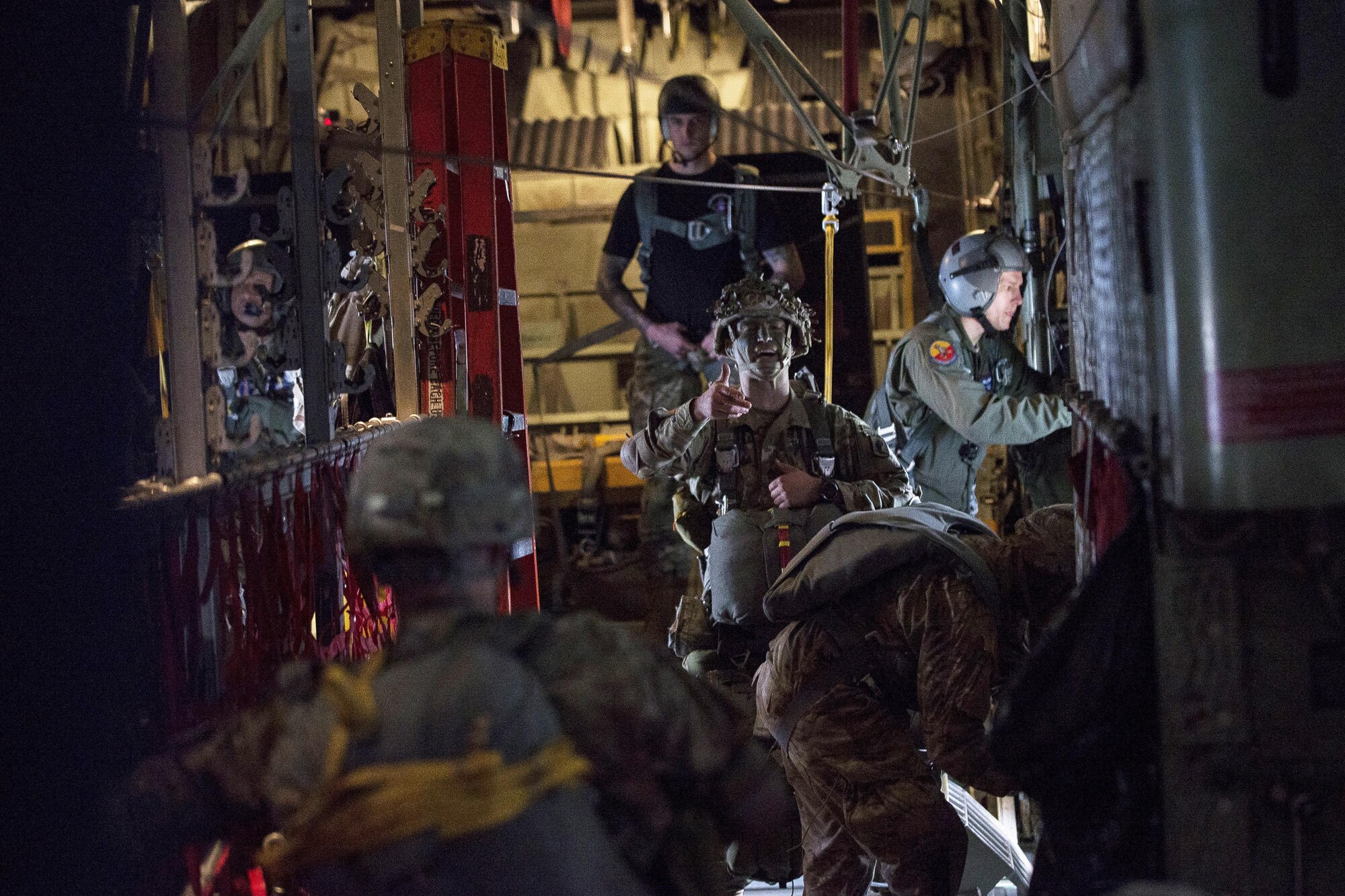 A jumpmaster inspects paratroopers prior to a jump over Mimon, Czech Republic, during Exercise Saber Junction 17 on Aviano Air Base, Italy, April 27, 2017. U.S. and Czech paratroopers conducted a joint airborne operation and airfield seizure as a part of the exercise.  The U.S. paratroopers are assigned to the 173rd Airborne Brigade, 2nd Battalion, 503rd Infantry Regiment. Air Force photo by Senior Airman Cory W. Bush
