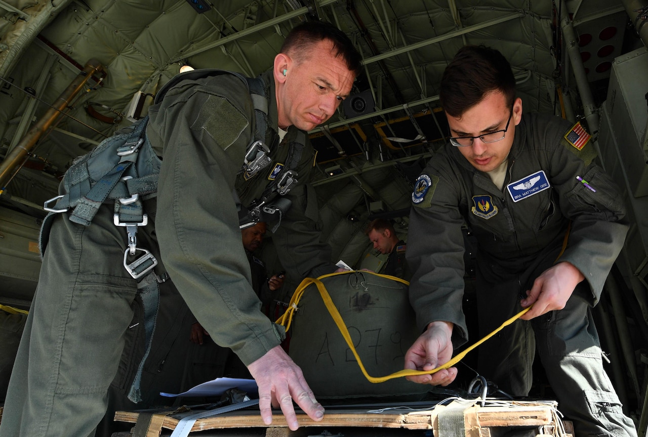 Air Force Senior Airman Matthew Gee, 37th Airlift Squadron loadmaster, right, prepares cargo for an airdrop while Air Force Master Sgt. CJ Campbell, 37th AS aircraft loadmaster, supervises during Exercise Stolen Cerberus IV at Elefsis Air Base, Greece, April 19, 2017. Gee, Campbell, and another loadmaster worked with the Hellenic air force to set up four airdrops of cargo. Air Force photo by Senior Airman Tryphena Mayhugh