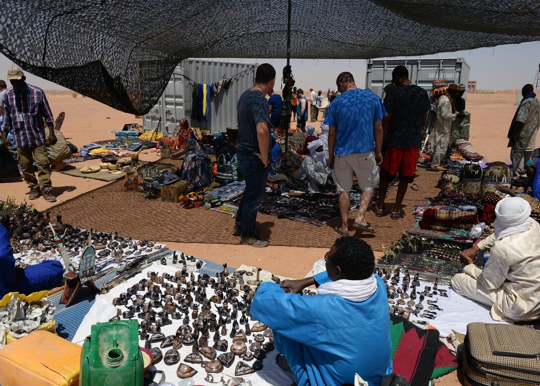 Airmen deployed to the 724th Expeditionary Air Base Squadron browse through merchandise during a bazaar at Nigerien Air Base 201, Niger, April 16, 2017. The bazaar is currently a bi-monthly event that allows the opportunity for Airmen to interact with the local community and help stimulate the economy. (U.S. Air Force photo by Senior Airman Jimmie D. Pike)