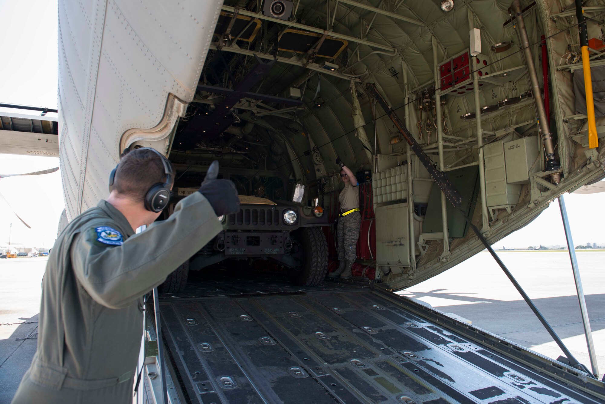 U.S. Air Force Master Sgt. Cecil Johnson, a 37th Airlift Squadron load master gives an all clear for a Humvee to drive off a C-130J Super Hercules April 26, 2016, at Incirlik Air Base, Turkey. The Humvees will be used by the 39th Security Forces Squadron for flightline security. (U.S. Air Force photo by Airman 1st Class Devin M. Rumbaugh)