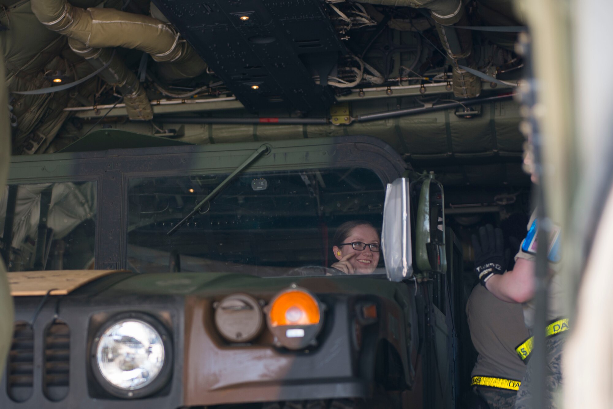 U.S. Air Force Senior Airman Cayla Cotter, a 728th Air Mobility Squadron air transportation specialist, prepares a Humvee to be offloaded onto the flightline April 26, 2017, at Incirlik Air Base, Turkey. The Humvees will be used by the 39th Security Forces Squadron for flightline security. (U.S. Air Force photo by Airman 1st Class Devin M. Rumbaugh)