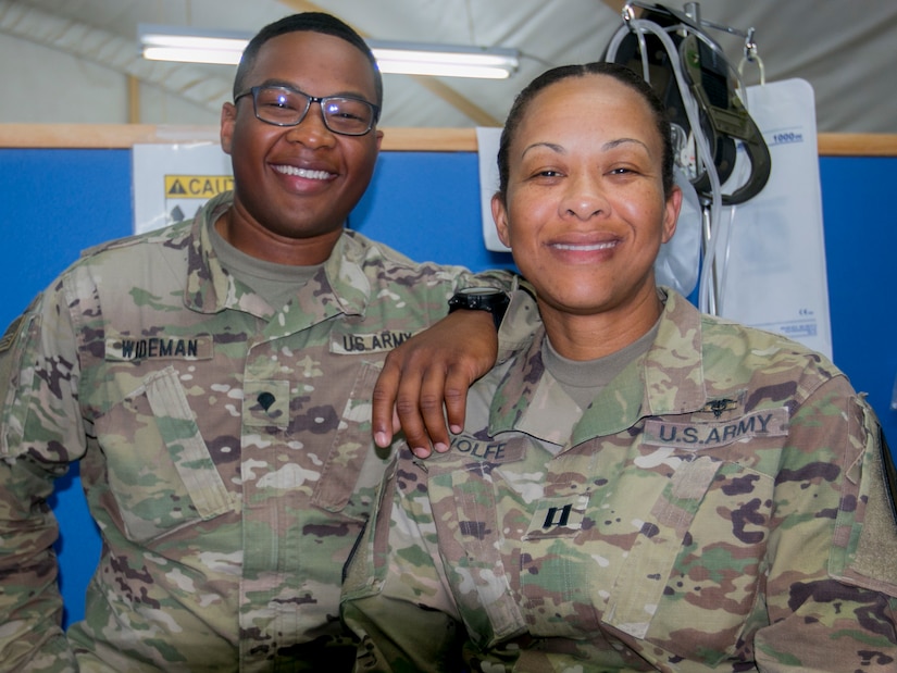 Army Capt. Andrea Wolfe, senior brigade physician assistant, and her son, Army Spc. Kameron Wideman, a behavioral health technician, both assigned to the Brigade Support Medical Company, 215th Brigade Support Battalion, are deployed for nine months to Camp Buehring, Kuwait. Army photo by Staff Sgt. Leah R. Kilpatrick