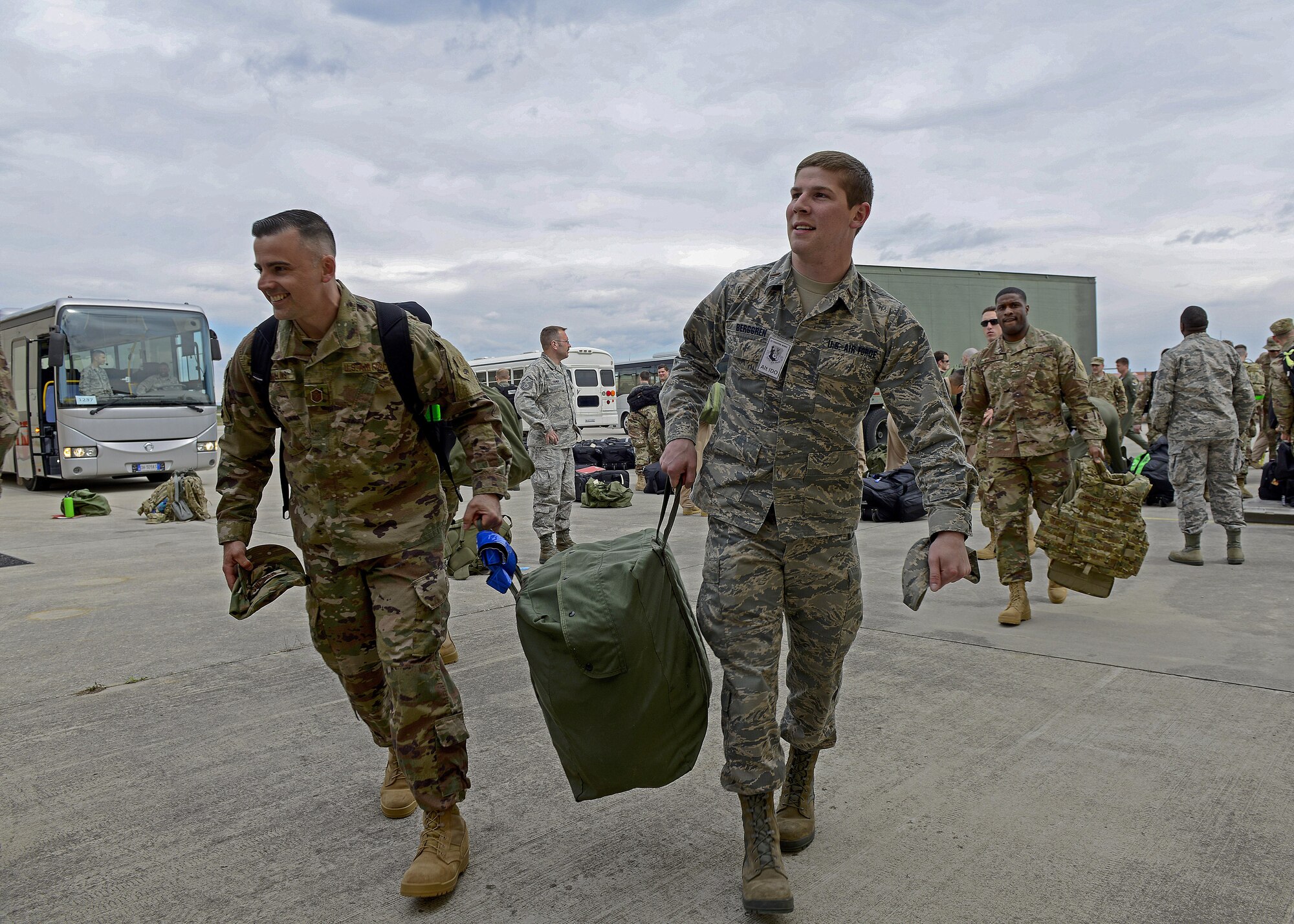 Master Sgt. Justin Mullins, 31st Aircraft Maintenance Squadron first sergeant, and 2nd Lt. Jacob Berggren, 31st Logistics Readiness Squadron assistant installation deployment officer, carry a deployment bag at Aviano Air Base, Italy, April 19, 2017. The 31st LRS assisted in deploying 344 service members from Aviano Air Base to Bagram Airfield. (U.S. Air Force photo by Airman 1st Class Ryan Brooks)