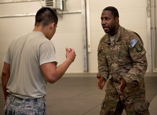 Tech. Sgt. Carl Bryant, right, 86th Security Forces Squadron program manager, instructs Airman 1st Class Damien Monreal, 86th Security Forces Squadron alarm monitor, on baton combative techniques on Ramstein Air Base, Germany, April 27, 2017. Rogers participated in a full-day training to test and prepare him for the Phoenix Raven qualification course on Fort Dix, NJ. (U.S. Air Force photo by Senior Airman Elizabeth Baker/Released)