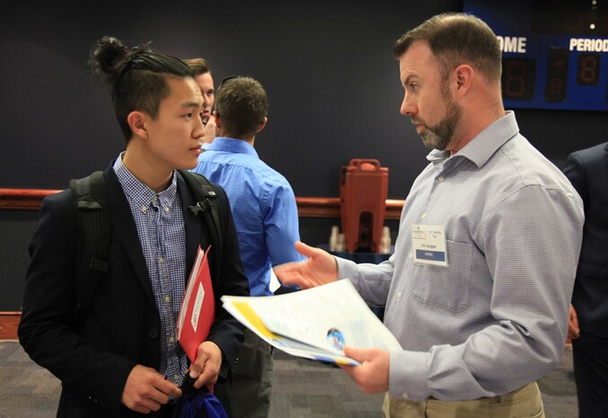 Mid-Atlantic Regional Maintenance Center (MARMC) Procurement Analyst Eric Dieges (right) speaks to an Old Dominion University (ODU) student about MARMC’s Contracting Department during the ODU 2017 Spring Career Fair, Mar. 23. (Photo by Shelby West, Public Affairs Specialist)