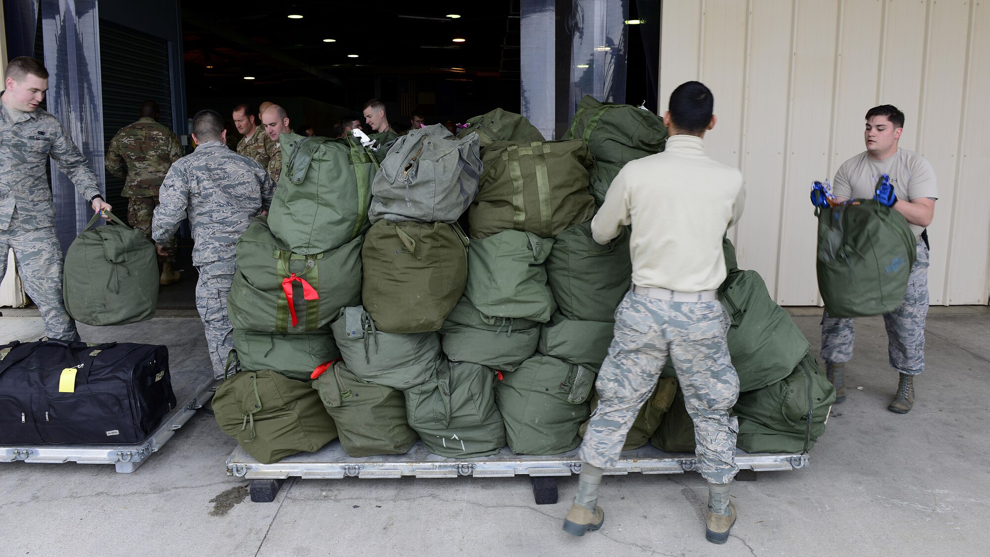 Airmen from the 31st Logistics Readiness Squadron stack deployment bags at Aviano Air Base, Italy, April 19, 2017. The 31st LRS assisted in deploying 344 service members from Aviano Air Base to Bagram Airfield. (U.S. Air Force photo by Airman 1st Class Ryan Brooks)
