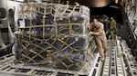 U.S. Air Force Maj. Robert Riggs, U.S. Marine Corps Forces, Special Operations Command air mobility liaison officer, assists in loading cargo aboard a C-17 aircraft at Marine Corps Air Station Cherry Point, North Carolina. As MARSOC’s AMLO, Riggs provides a critical link of communication between the airlift and ground forces in the area of operations. He facilitated the mission from planning and coordination through hands-on facilitation by piloting the aircraft as it deployed and re-deployed two MARSOC units.