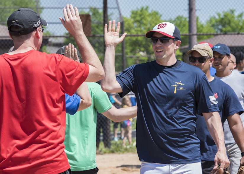 “Strike Out Sexual Assault” Softball Tournament participants high-five after a game at Joint Base Andrew, Md., April 28, 2017. The competition was held in conjunction with Sexual Assault Awareness and Prevention Month, the goal of which to raise cognizance about sexual harassment and violence, and inform military members how to prevent it. (U.S. Air Force photo by Senior Airman Jordyn Fetter)