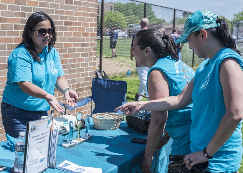 Participants of the “Strike Out Sexual Assault” Softball Tournament stop by the booth set up for Sexual Assault Awareness and Prevention Month at Joint Base Andrews, Md., April 28, 2017. The month is focused on prevention, caring for victims and taking appropriate action against offenders. (U.S. Air Force photo by Senior Airman Jordyn Fetter)