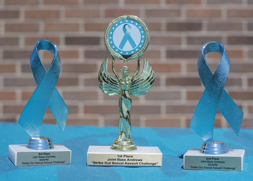 Trophies for the “Strike Out Sexual Assault” Softball Tournament rest on a table at Joint Base Andrews, Md., April 28, 2017. The competition was held in conjunction with Sexual Assault Awareness and Prevention Month, the goal of which to raise cognizance about sexual harassment and violence, and inform military members how to prevent it. (U.S. Air Force photo by Senior Airman Jordyn Fetter)