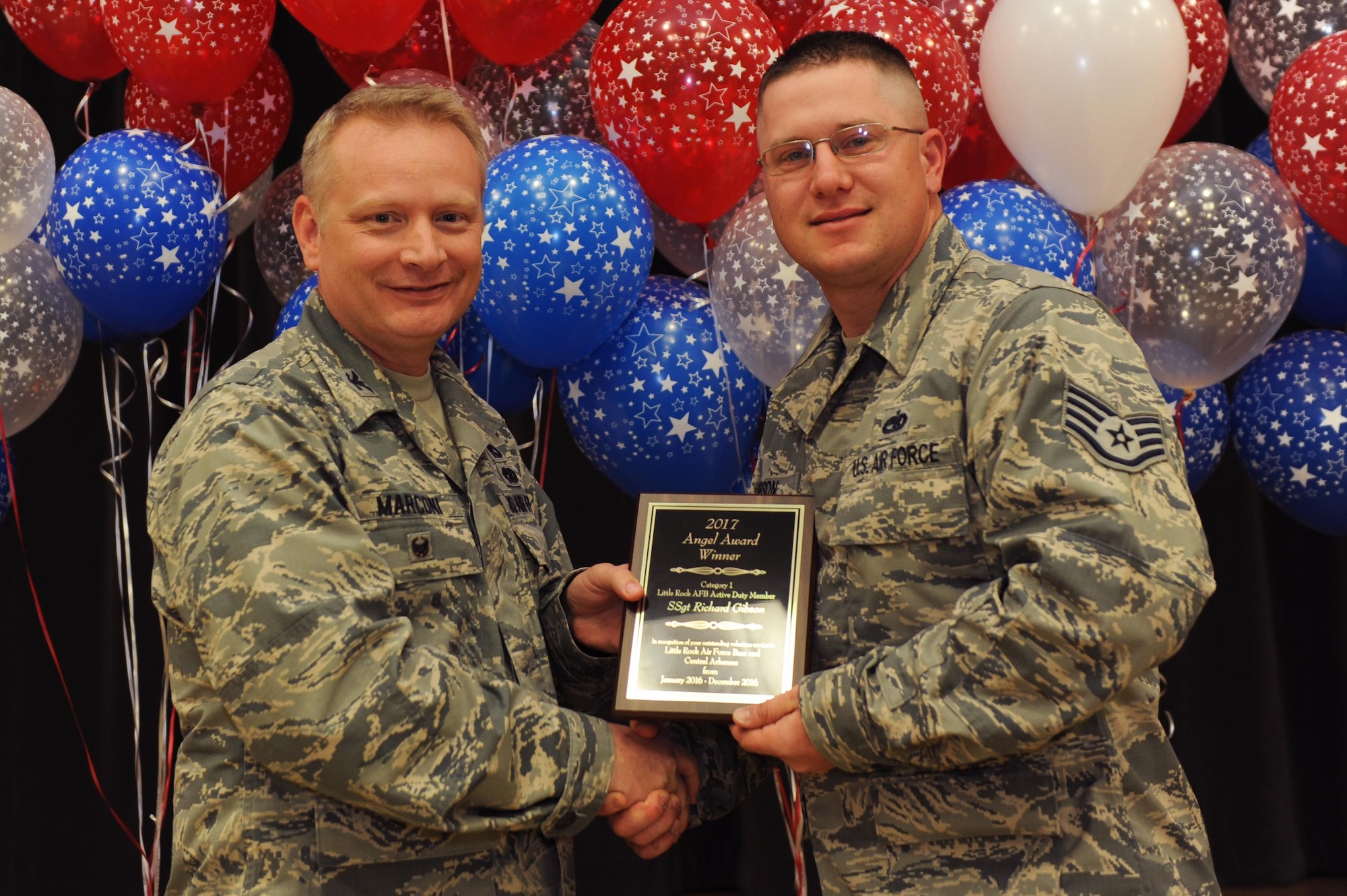 Staff Sgt. Richard Gibson, 19th Maintenance Squadron cyber security liaison, receives the Individual Volunteer award during the Airman & Family Readiness Center Volunteer Program ceremony, April 27, 2017 at Little Rock Air Force Base, Ark. Gibson dedicated more than 300 hours to the base and community at his church and surrounding organizations. (U.S. Air Force photo by Airman 1st Class Grace Nichols)