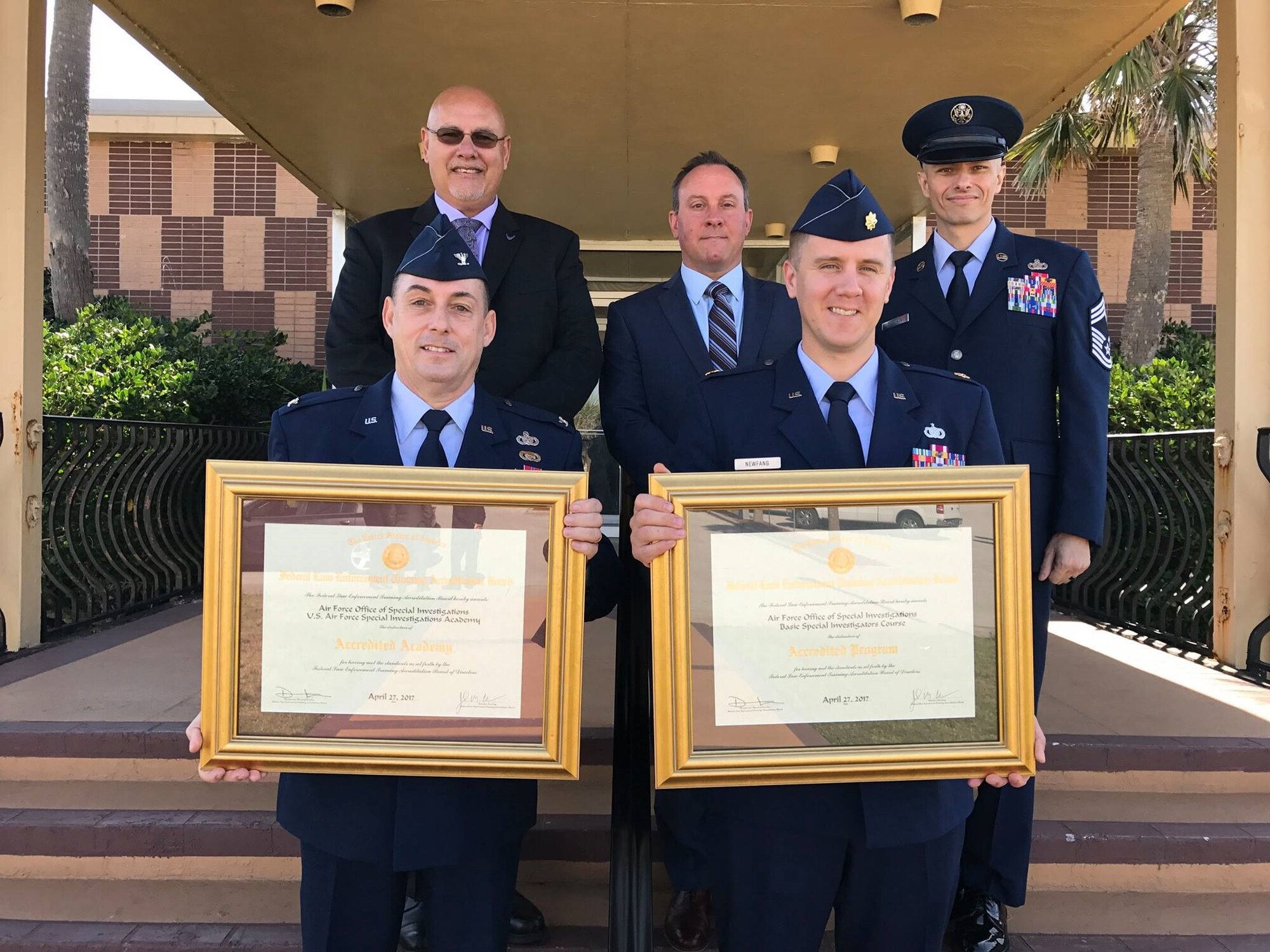 Col. Garry Little, AFSIA Commander, and Maj. Seth Newfang, AFSIA Chief, Basic Training Division, proudly show the reaccreditations AFSIA and the AFOSI Basic Investigators Course were granted by the Federal Law Enforcement Training Accreditation Board April 27, 2017. Joining them are, left to right, Mr. Dave Bynum, AFSIA Chief, Training Management Division, Mr. Greg Lynch, AFSIA Deputy Director and Chief Master Sgt. Gregory Carmack, AFSIA Superintendent. (AFSIA photo)     