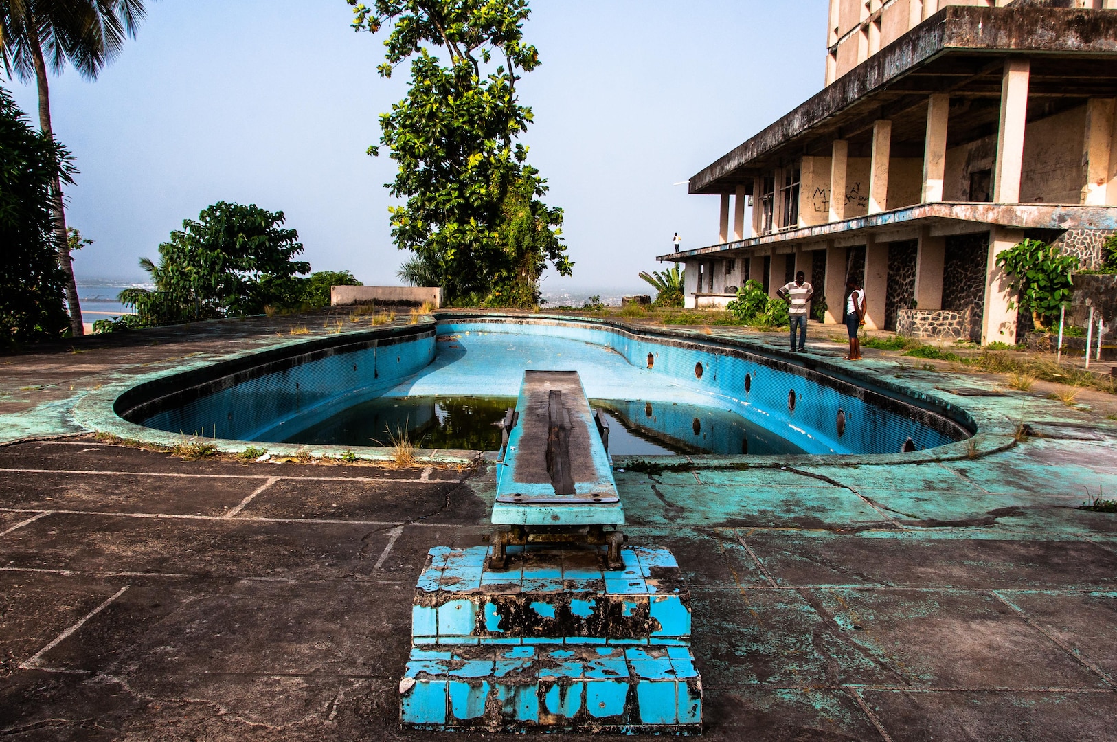 The swimming pool area of the former Ducor Palace Hotel in Monrovia, Liberia.

The Ducor Palace Hotel in Monrovia was the first international-class hotel constructed in Liberia, and was for many years one of the few five-star hotels in all of Africa. It had three hundred rooms, a pool, tennis courts, and a French restaurant and was popular with tourists and businesspeople from Africa and around the world.  It sits on Ducor Hill and overlooks the Atlantic Ocean and the Saint Paul River.

The hotel closed in 1989, just before the First Liberian Civil War. The building was severely damaged by the violence of the war and the looting that occurred afterwards. During and after the war, displaced residents of many of Monrovia's slums began to occupy the hotel's empty rooms.  In 2007, the Liberian Ministry of Justice began to evict the Ducor Hotel's residents and in 2008, the Government of Liberia signed a lease agreement with the Government of Libya, who began clearing the property of debris in 2010 in preparation for a bidding process to be completed by June 2010. The project was delayed several times before finally being abandoned upon Liberia's severing of diplomatic relations with the Gaddafi government following the outbreak of the 2011 Libyan civil war.

The building is open today and visitors can walk throughout the grounds and building (often after paying a "security fee" to have one of the guards accompany them).  It is a popular place for Monrovia residents to come and enjoy the panoramic view of the city, especially for special occasions like Christmas, New Years, and Independence Day.