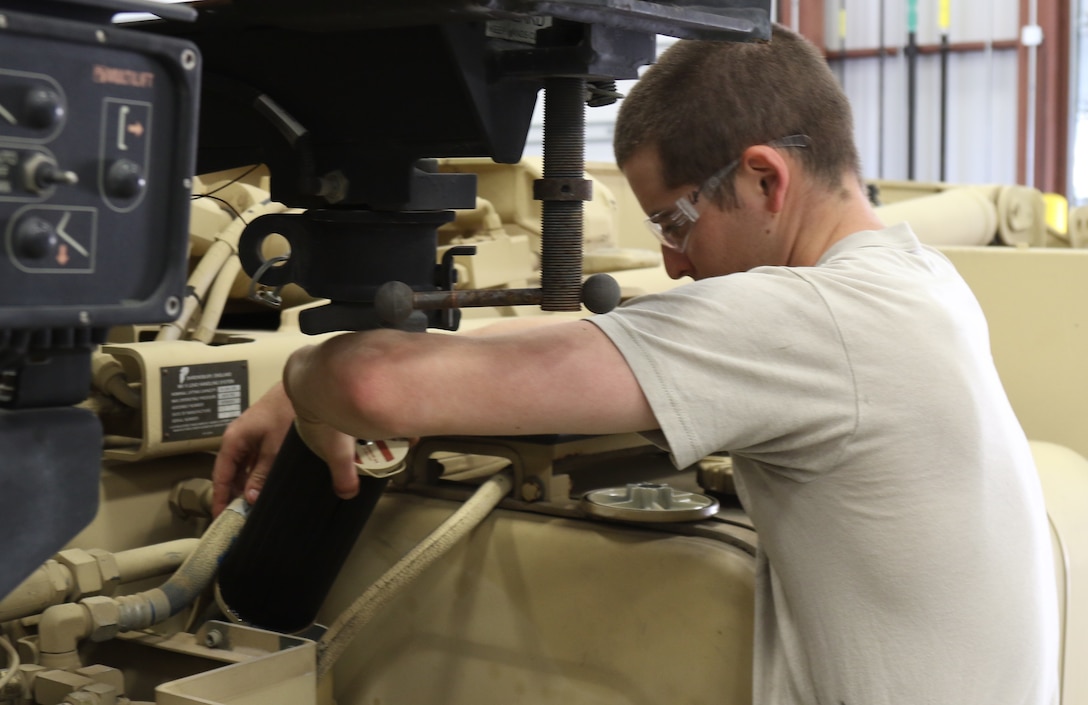 U.S Army Reserve Spc. Chris Pierce, a wheeled vehicle mechanic with the 851st Transportation Company, based in Sinton, Texas, conducts maintenance on a M1075A1 Palletized Load System during Vibrant Response and Guardian Response near Camp Atterbury, Indiana, Apr. 25, 2017.  Vibrant Response and Guardian Response bring together military, federal and state agencies from throughout the continental U.S. for three weeks of collective training simulating the response to a catastrophic Chemical Biological Radiological Nuclear (CBRN) event in a major U.S. city.  (U.S. Army Reserve Photo by Maj. Brandon R. Mace)