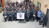 Commander, Navy Regional Maintenance Center Rear Adm. James P. Downey and MARMC Commanding Officer Daniel Lannamann pose with the most recent MARMC NAMTS graduating class. (Photo by Chris Wyatt, Public Affairs Specialist)