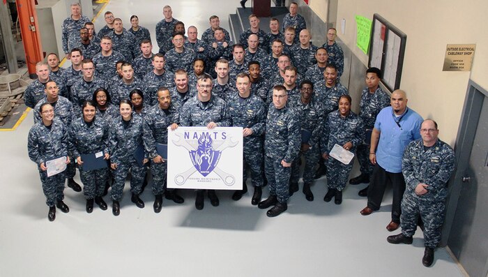 Commander, Navy Regional Maintenance Center Rear Adm. James P. Downey and MARMC Commanding Officer Daniel Lannamann pose with the most recent MARMC NAMTS graduating class. (Photo by Chris Wyatt, Public Affairs Specialist)