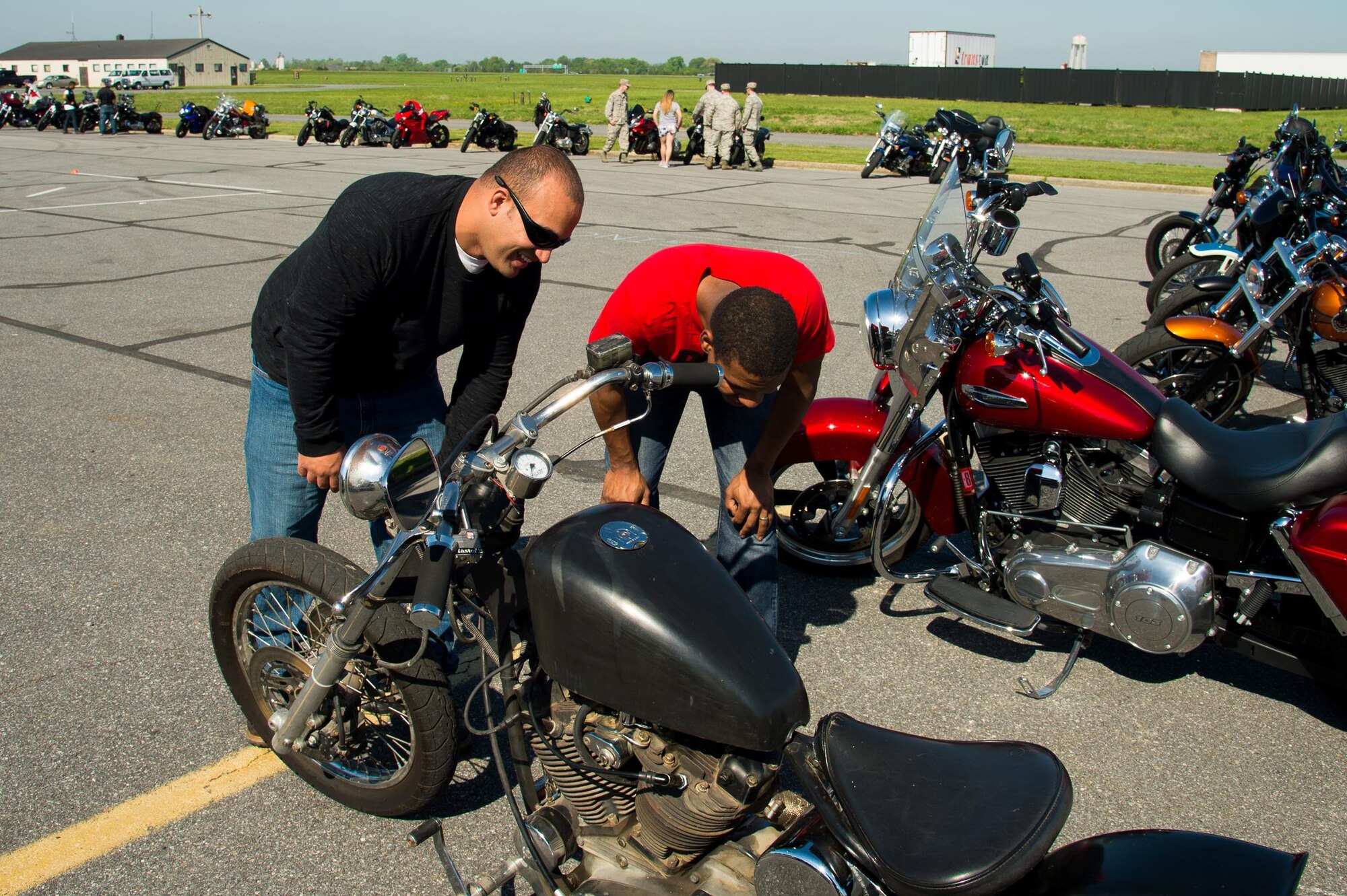 Team Dover Airmen admire a motorcycle’s artwork and modifications at the Motorcycle Safety Day April 28, 2017, at Dover Air Force Base, Del. The annual event is aimed at preventing future mishaps through the dissemination of motorcycle safety knowledge and a spirit of mentorship. (U.S. Air Force photo by Mauricio Campino)