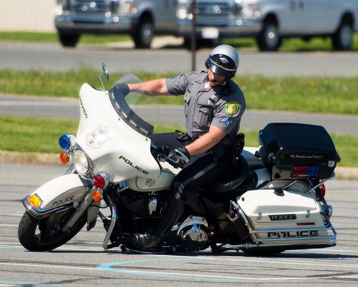 Cpl. Brian Allen, Dover Police Department, performs a tight left turn during the Motorcycle Safety Day April 28, 2017, at Dover Air Force Base, Del. Allen demonstrated the extremes to which officers can push their bikes after receiving proper training and practice. (U.S. Air Force photo by Mauricio Campino)