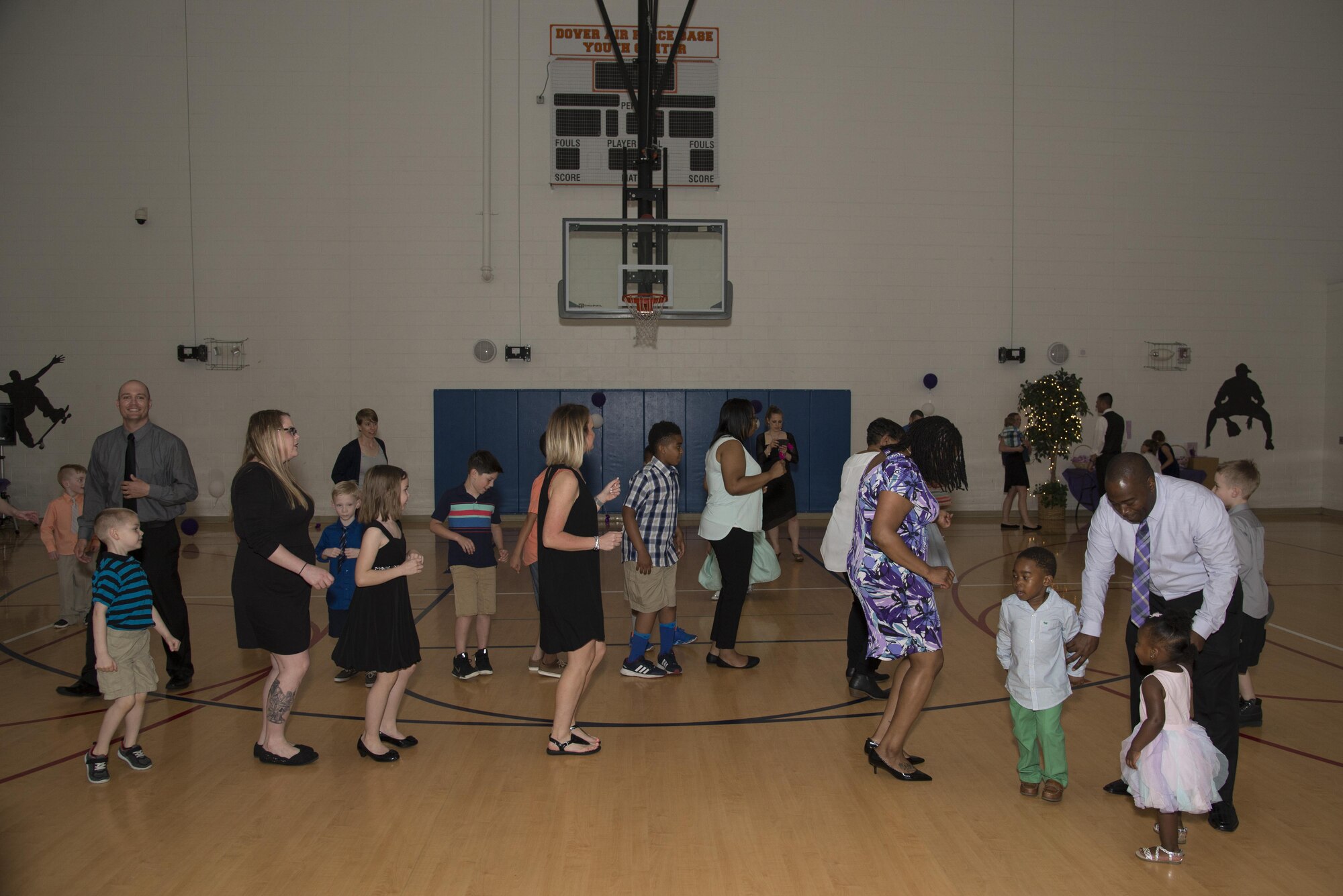 Families of Team Dover celebrate the Month of the Military Child during the inaugural Purple Ball April 29, 2017, at the Youth Center on Dover Air Force Base, Del. The color purple – the combination of Air Force blue, Navy blue, Coast Guard blue, Army green and Marine red – has come to represent military children and their unity. (U.S. Air Force photo by Senior Airman Aaron J. Jenne)
