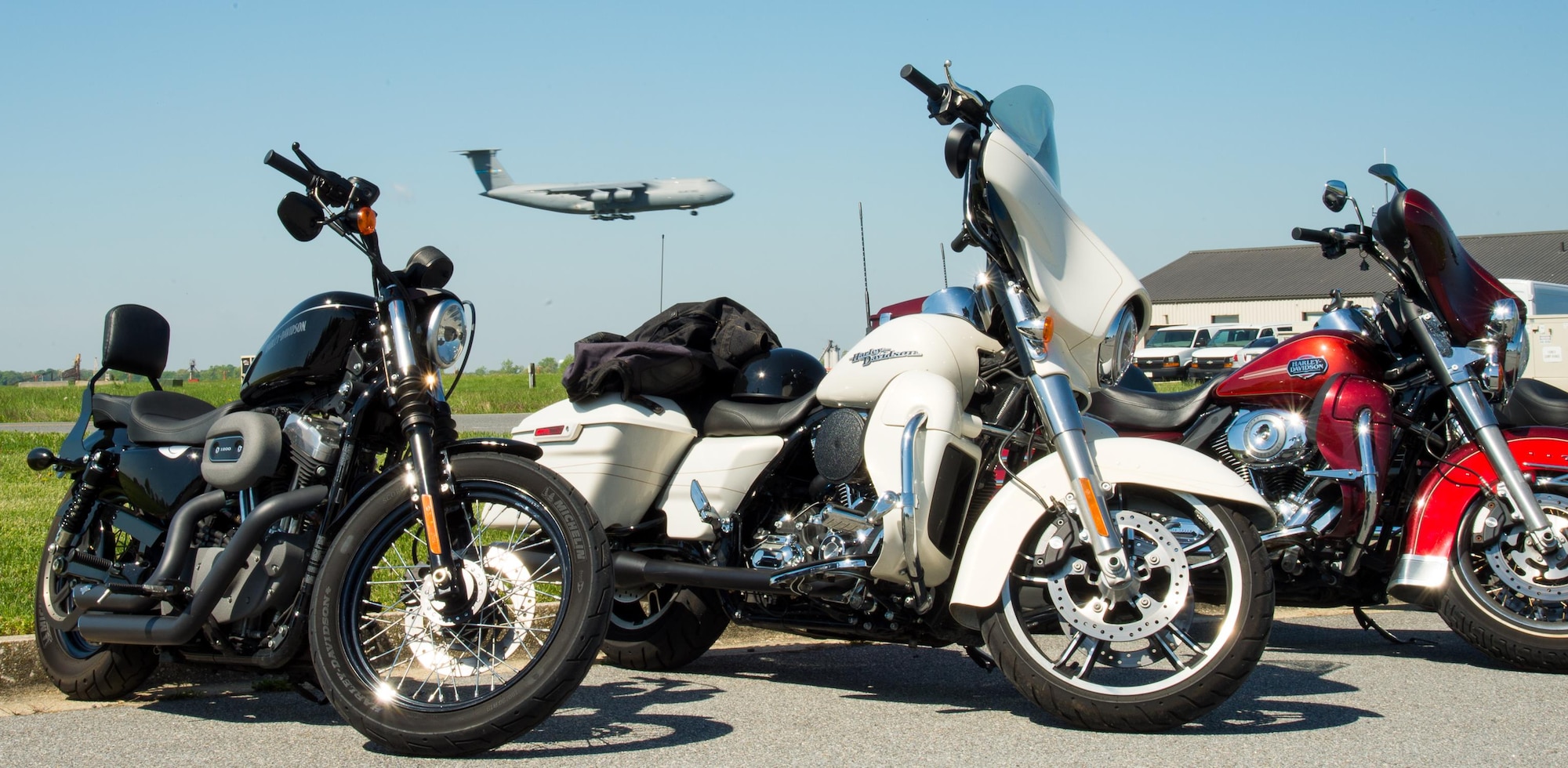 Harley Davidsons parked at the Motorcycle Safety Day while a C5 “Super Galaxy” flies by April 28, 2017, at Dover Air Force Base, Del. Approximately 175 riders from the 436th Airlift Wing attended the Annual Pre-Season Brief and many stayed to enjoy the day’s events. (U.S. Air Force photo by Mauricio Campino)