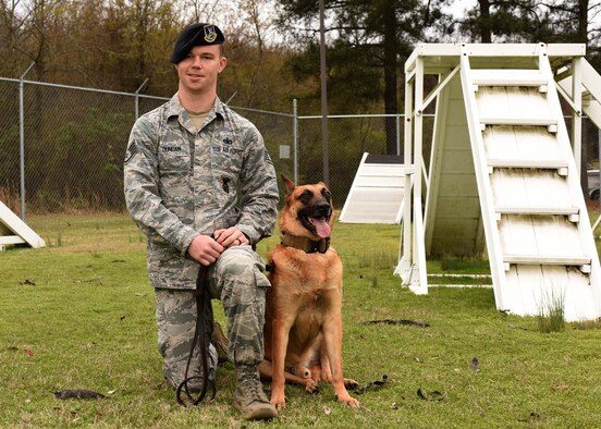 Staff Sgt. Tommy Duncan, 19th Security Forces Squadron K9 trainer, and Ricsi, retired military working dog, pose for a photo March 17, 2017, at Little Rock Air Force Base, Ark. Duncan adopted Ricsi after the dog retired in September 2016. (U.S. Air Force photo by Senior Airman Mercedes Taylor)