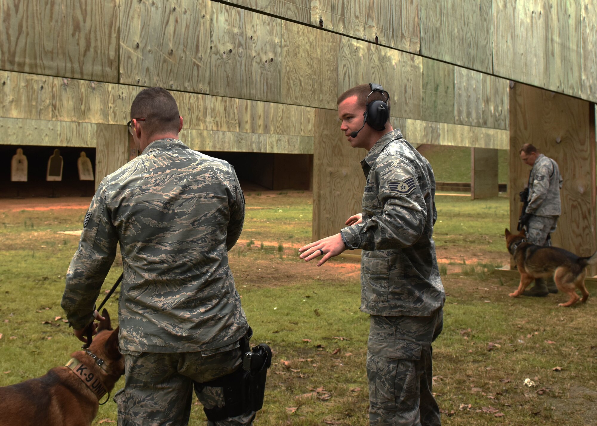 Staff Sgt. Tommy Duncan, right, 19th Security Forces Squadron K9 trainer, advises Staff Sgt. Jake Craig, 19th SFS K9 handler, during gunfire training March 16, 2017, at Little Rock Air Force Base, Ark. Duncan is responsible for administering training for the unit’s dog teams. (U.S. Air Force photo by Senior Airman Mercedes Taylor) 