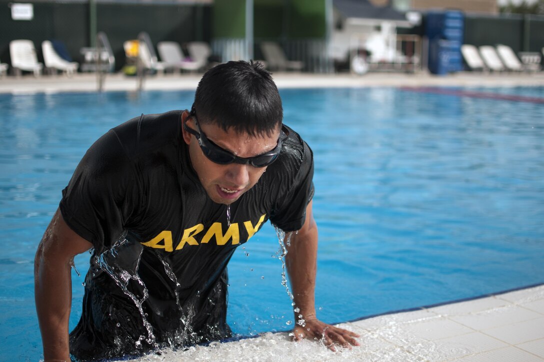 Chief Warrent Officer 2 Noris Molina with the 369th Support Battalion, exits the pool after completing the swim portion of the German Armed Forces Badge qualification. The German Armed Forces Badge for Military Proficiency is one of the most sought after foreign awards in the United States Army. The 316th ESC and the 1st Sustainment Command (Theater) had the privilage of hosting the award qualifications at Camp Arifjan, Kuwait April 27, 2017.