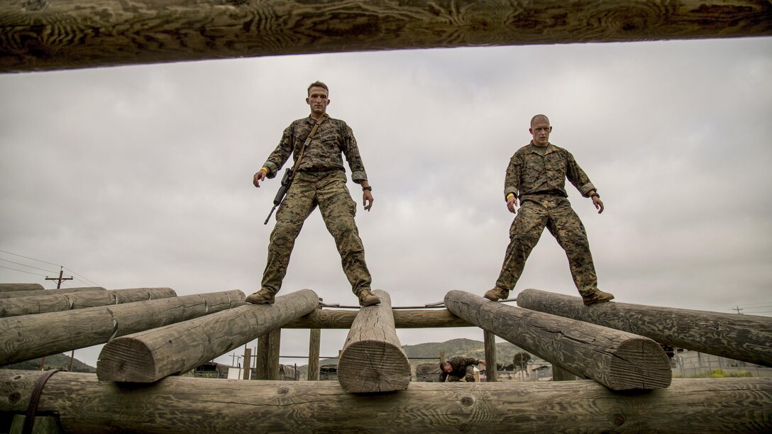 Marine Corps Capt. Cameron Heard, left, and Staff Sgt. Michael Birch  walk on logs during the inaugural Challenge Reconnaissance at Camp Pendleton, Calif., April 27, 2017. The challenge comprises 24 miles of hiking, helocasting, scout swimming, a memory challenge, obstacle course, live-fire range, close-quarters tactics and two pool stations. Marine Corps photo by Cpl. Brandon Martinez